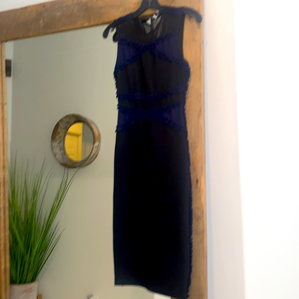 Below the knee primarily black mixed media high end dress. US small fits like 4.